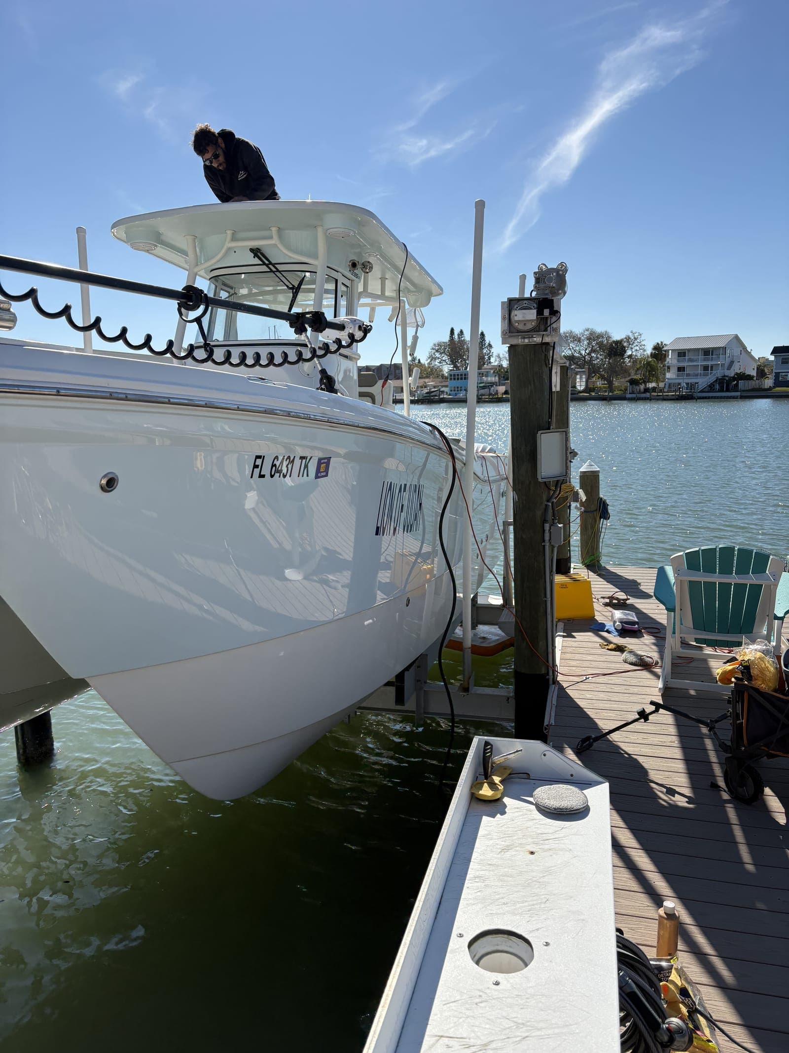 Mobile Marina technician working on a center console at a Tampa Bay dock during a scheduled detail visit