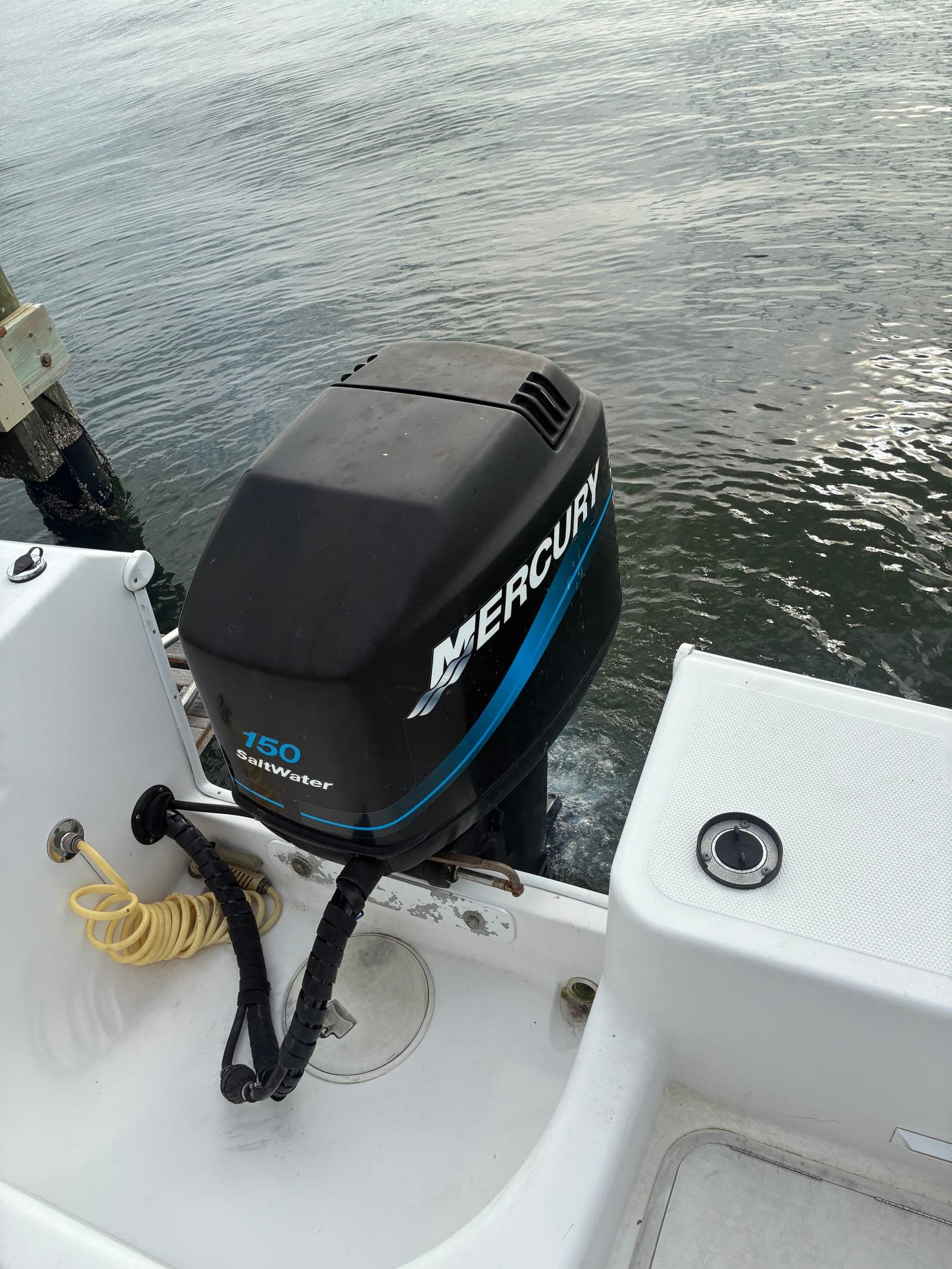 Mercury 150 FourStroke running on a Tampa Bay boat, telltale stream visible