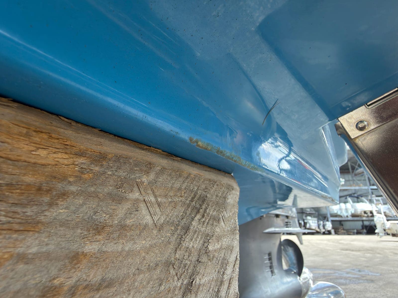 Boat hull supported on blocks at a marine repair facility for below-waterline work