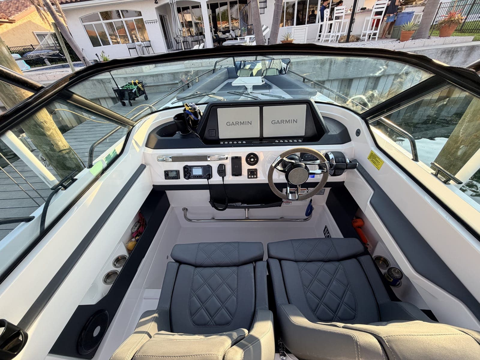 Center-console helm with twin Garmin displays — the kind of electronics every monthly inspection logs and photographs in the Mobile Marina app