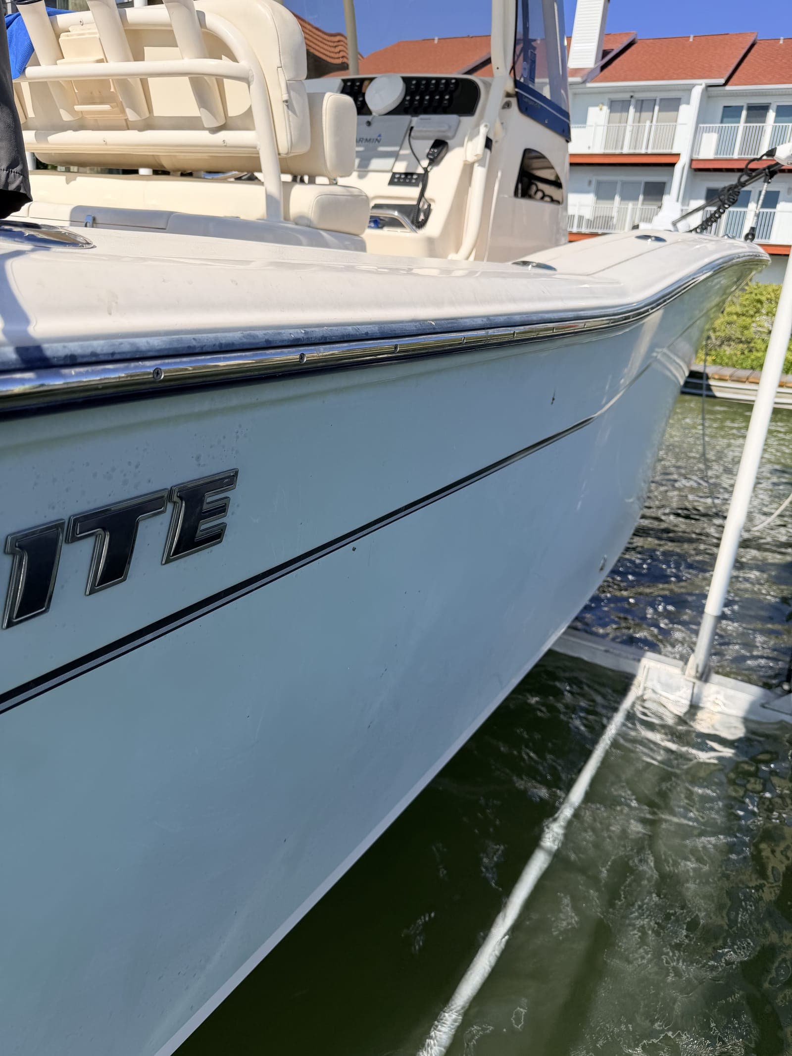 Aging gelcoat on a Tampa Bay center console showing the dulling and surface oxidation that Florida UV and salt exposure cause year-round