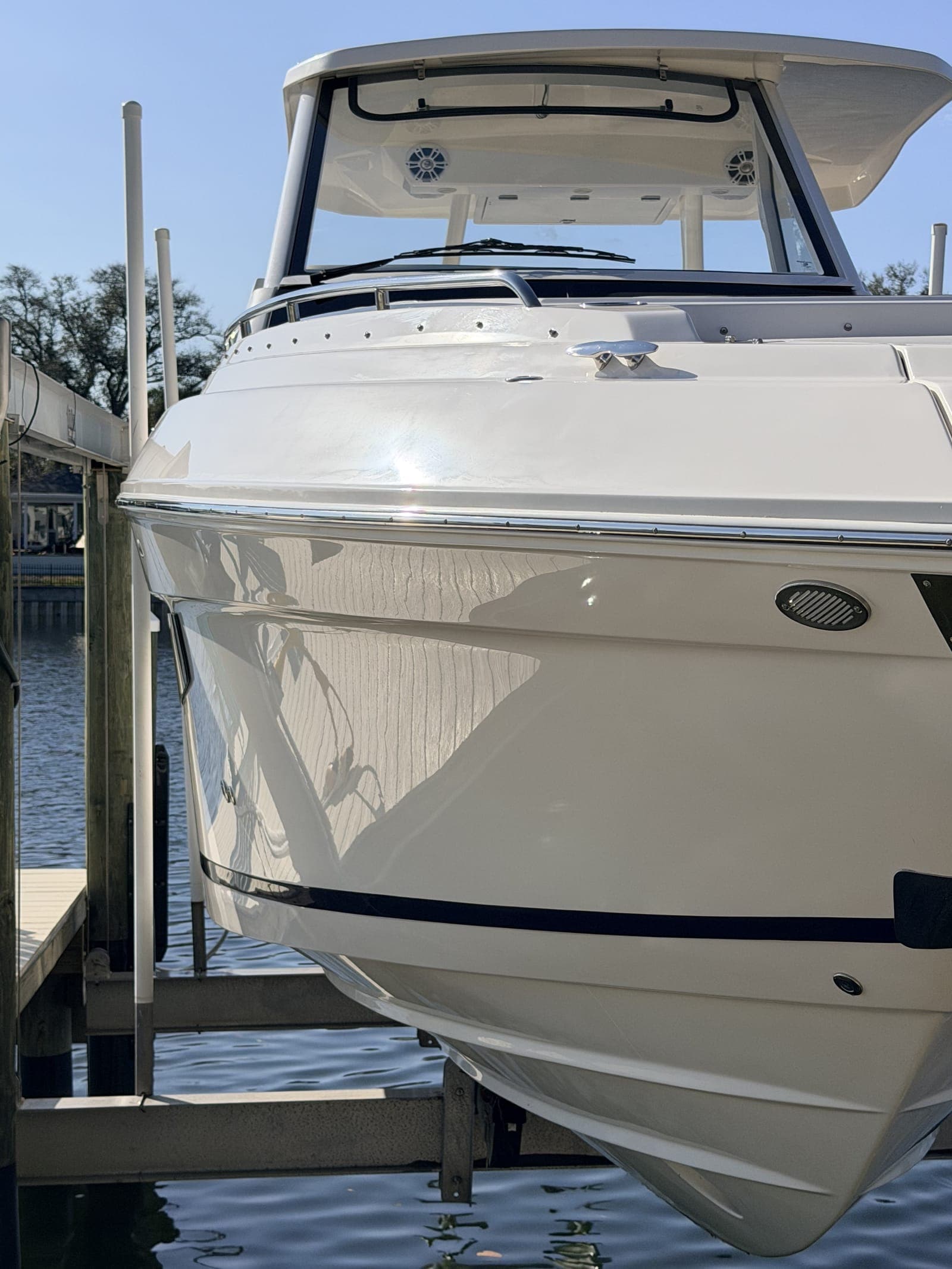 Sport cruiser bow on a lift at a Tampa Bay residential slip — the kind of recreational vessel Mobile Marina's yacht management program is built for