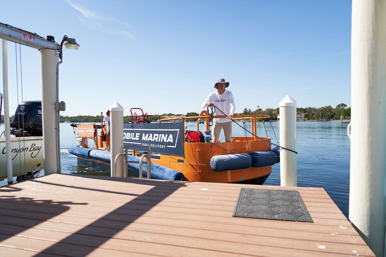 Mobile Marina captain preparing the fuel hose dockside before a delivery in Tampa Bay